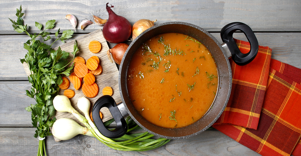 Top View On Pot Of Tomato Soup And Fresh Vegetables On Old Wooden Table