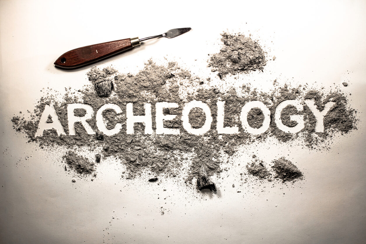 Archeology Word Written In Letters On A Pile Of Grey Ash, Dirt, Soil, Ground
