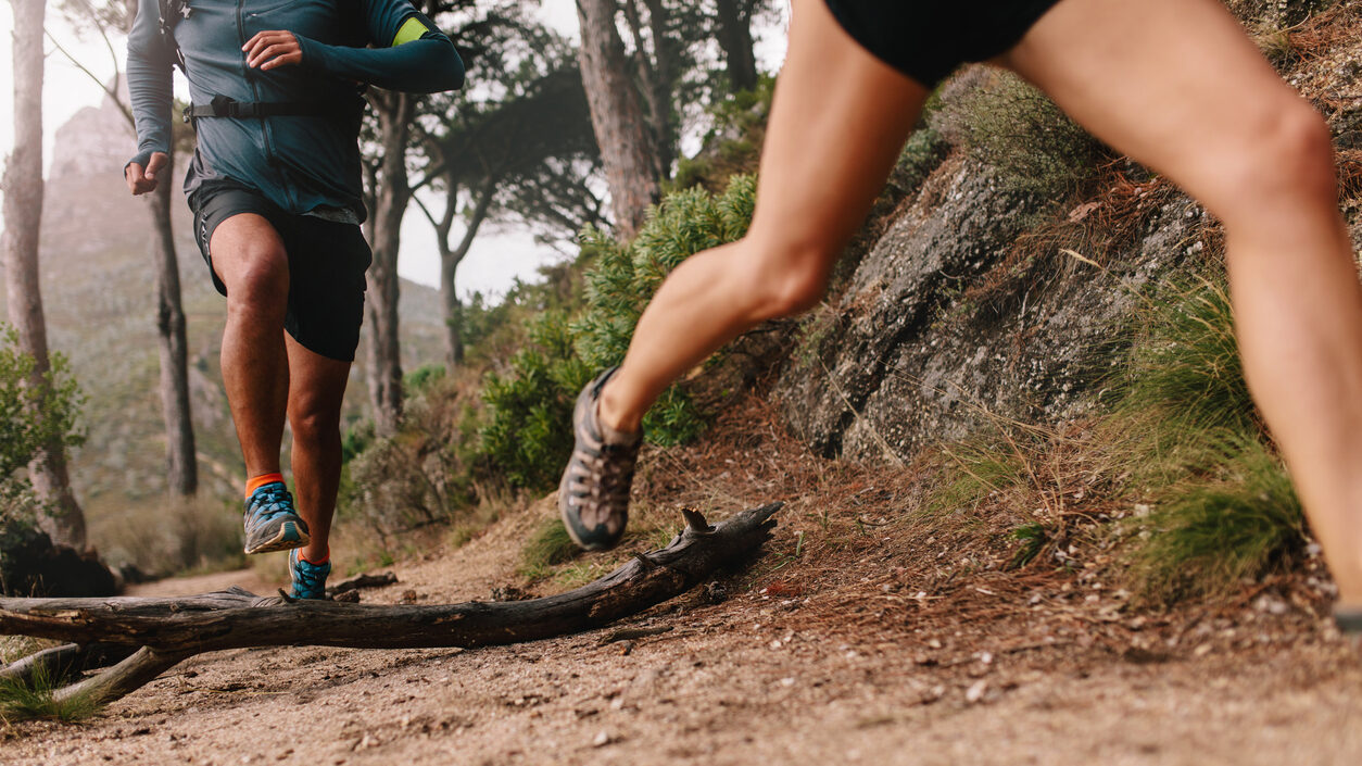 Runner Legs Running On Mountain Trail