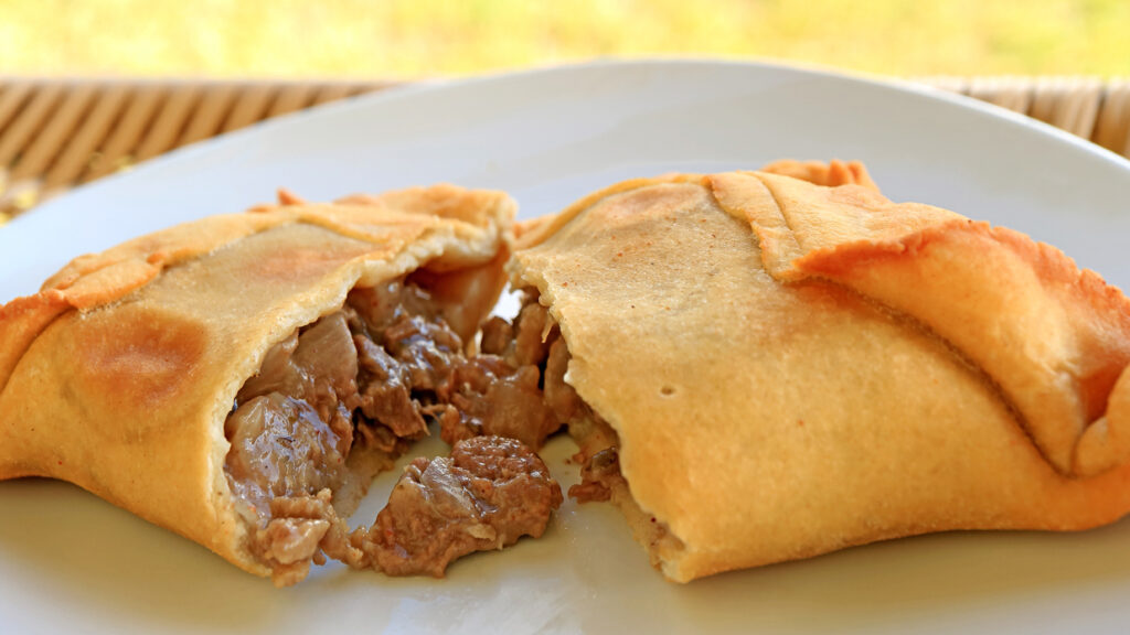 Empanada De Pino Or Beef Filled Empanada, Delicious Chilean Baked Pasty Served On White Plate