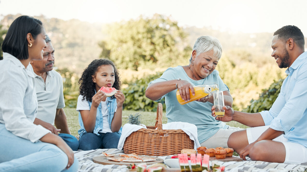 Shot Of A Family Enjoying A Picnic In A Park