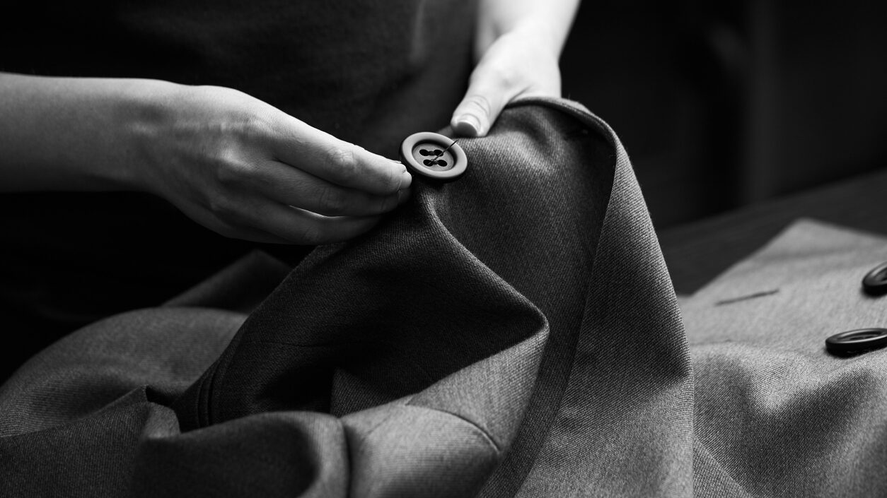 Sewing The Buttons To The Jacket