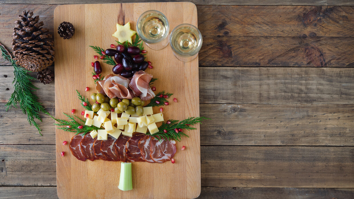 Christmas Tree Shaped Cheese And Charcuterie Board With Wooden Background. Top View. Copy Space.