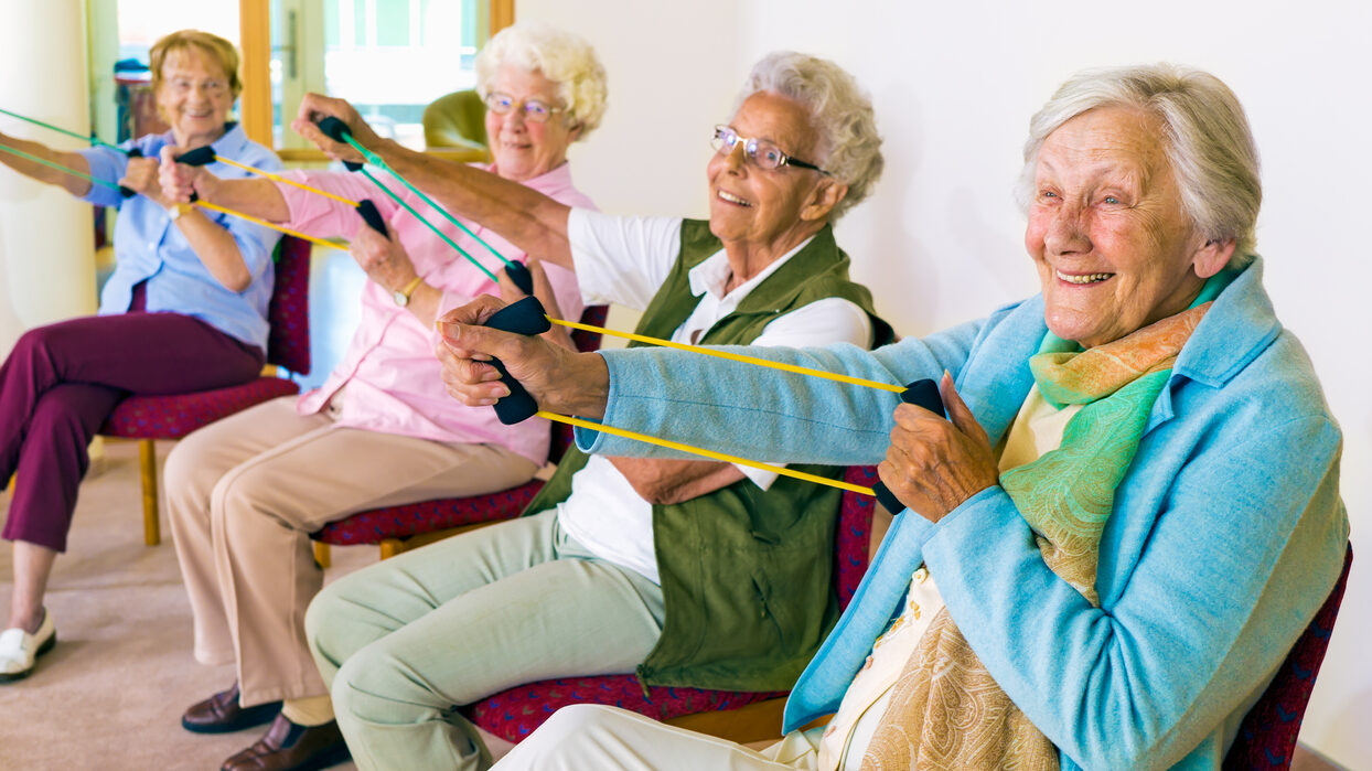 Cheerful Senior Women Exercising Their Arms.