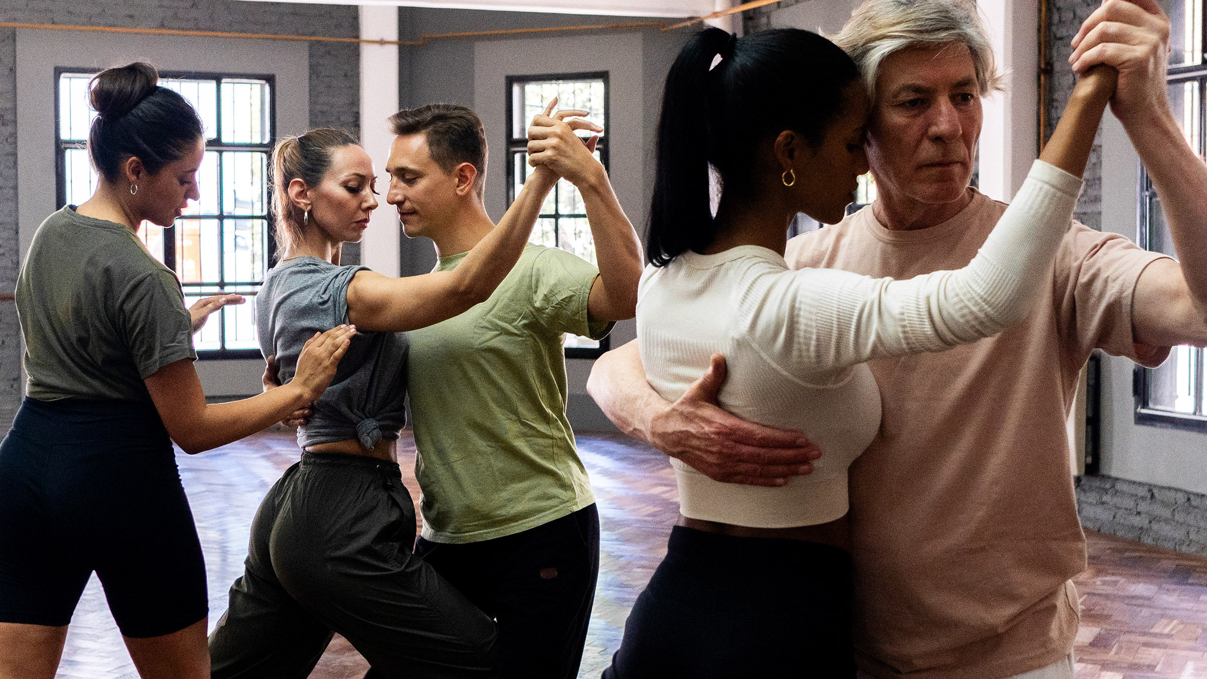 Instructor Teaching Students During Tango Class