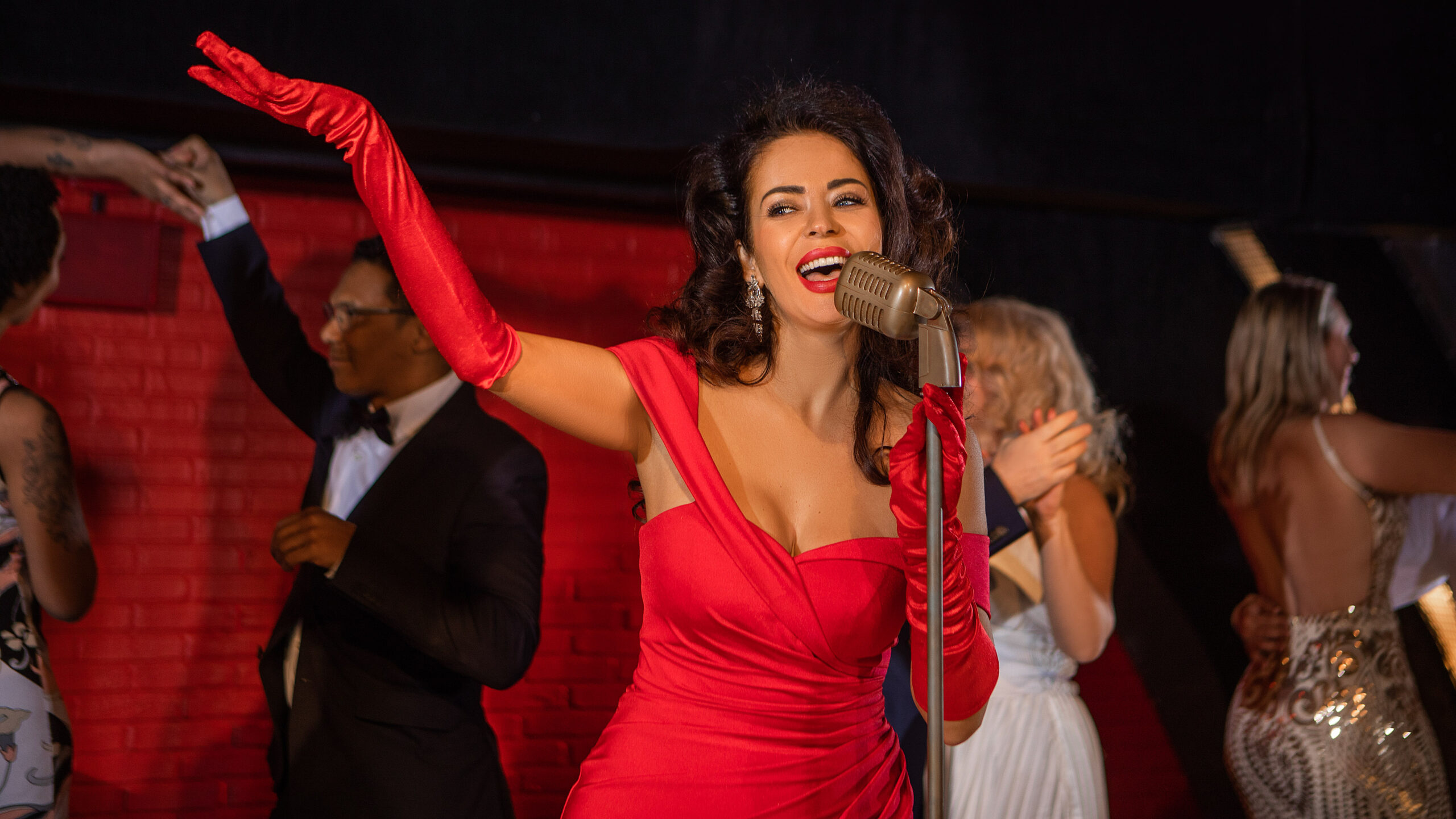 Beautiful Female Singer Performing On Stage With Dancers