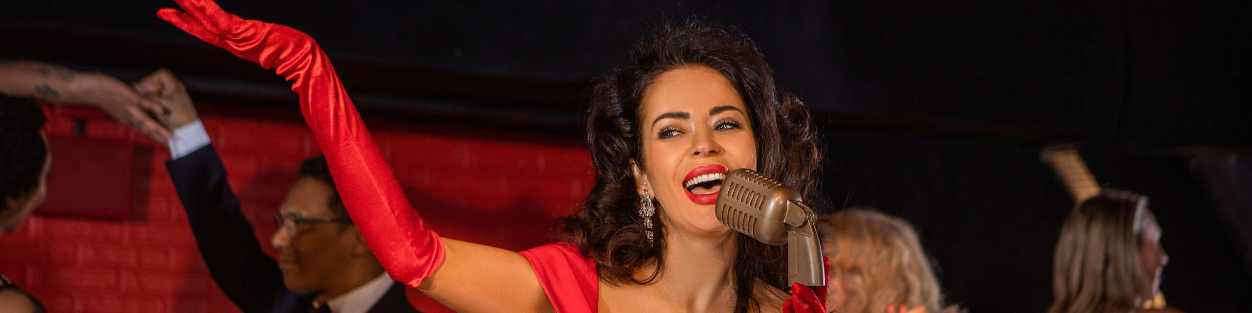 Beautiful Female Singer Performing On Stage With Dancers