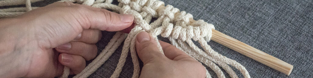 Macrame. Girl Weaves Macrame. White Thread, Female Hand, Grey Background, Close Up