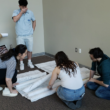 Kean students building forensic wall, 2025